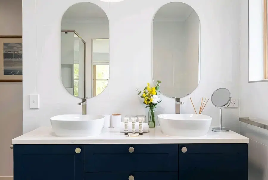 Renovated bathroom with dual vanity and oval mirrors, Sunshine Coast home renovation by TJS Build Groups