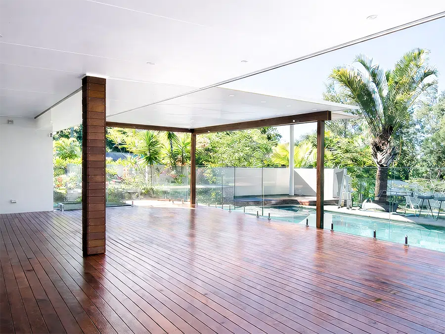 Timber deck outdoor living area overlooking the pool, built by TJS Build Groups on the Sunshine Coast